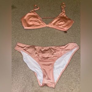 Pink peachy pink bathing suit almost silk material cute doesn’t show to much.